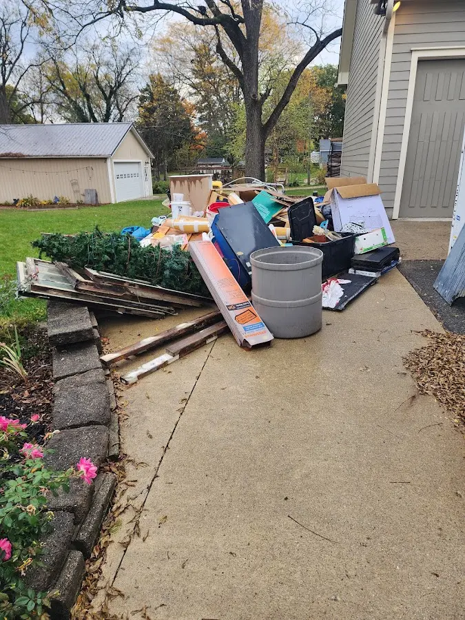 Dumpster being loaded with debris for Estate Cleanout Dumpster Rental in Hawkinsville
